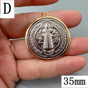 Close-up of a 35mm vintage gold Saint Benedict medal pendant held to show size scale