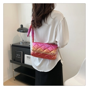 Close-up of pink and orange gradient crossbody bag with padded quilted rhombic pattern