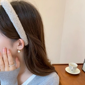 Detail view of French chic tweed headband, pearl ring, and gold ball earrings set