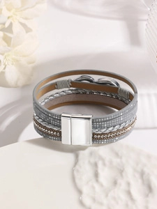 Detail of multi-layer gray leather bracelet with rhinestones and magnetic buckle