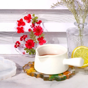 Macro detail of irregular resin coaster with dried flowers and silicone mold
