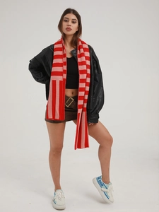 Close-up of knit striped scarf in red and pink with soft cashmere-like texture