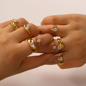 Minimalistische vergoldete Edelstahlringe mit Zirkonia an den Händen des Models
