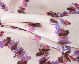 Macro shot of high-quality silk satin fabric with abstract brown and purple floral patterns