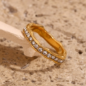 Macro shot of 18K gold plated irregular wave ring with sparkling crystal pave setting
