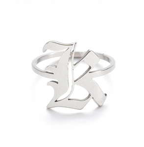 Detailed macro view of silver Gothic style letter K engraved on a stainless steel ring