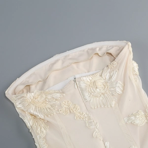 Detailed close-up of intricate 3D floral embroidery and invisible zipper on white gown
