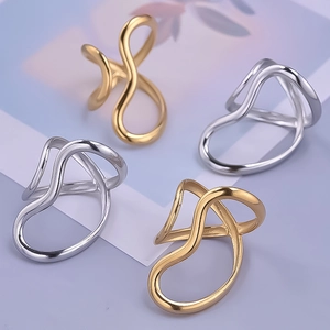 Macro shot of abstract wavy stainless steel rings in gold and silver finishes
