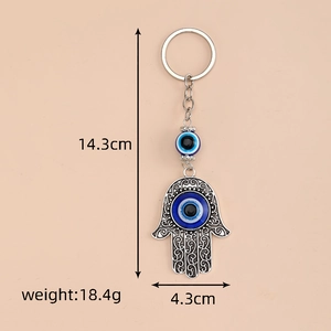 Silver Hamsa Hand keychain with blue Evil Eye bead, 14.3cm height and 18.4g weight
