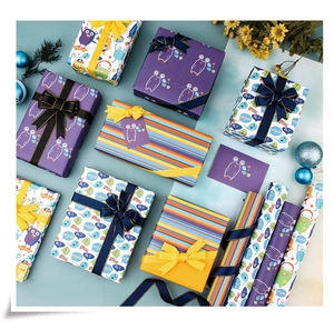 Close-up of cute cartoon purple prints and colorful striped gift wrapping paper set