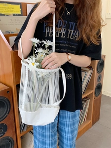 Minimalist white mesh tote bag with canvas base shown in a vintage lifestyle setting