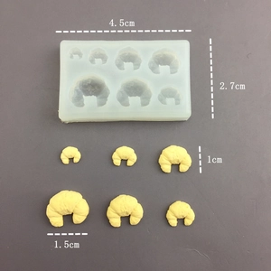 Macro detail of silicone mold for mini croissants with specific size measurements