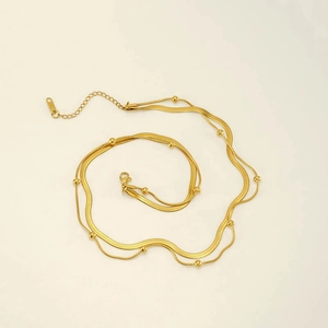 Zweilagige goldene Edelstahl-Halskette mit kleinen Perlen und Hummerverschluss-Detail