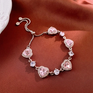 Macro shot of rose gold adjustable heart bracelet with pink zircon and clear crystals