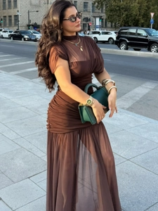Detail of dark brown stretch mesh dress featuring high neck and pleated waist design