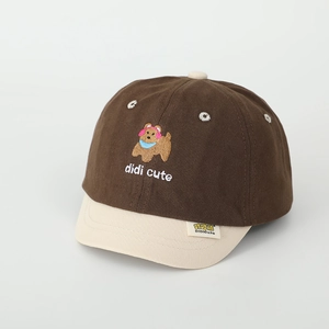 Detailed close-up of cartoon puppy embroidery and beige brim on children baseball cap