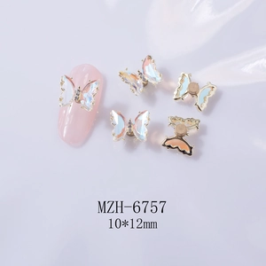 Close-up of 3D rotating pink butterfly nail art charms with aurora crystal wings