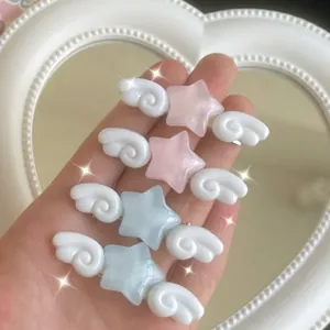 Sweet jelly star hair clips with white angel wings in pastel pink and blue colors