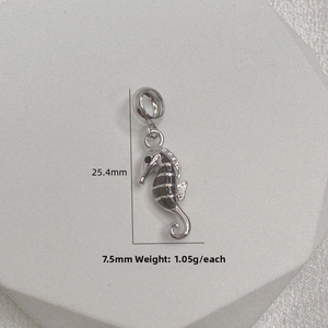 Macro detail of S925 silver seahorse charm with dimensions 25.4mm by 7.5mm