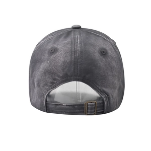 Detail view of washed cotton baseball cap featuring adjustable fabric strap and metal buckle