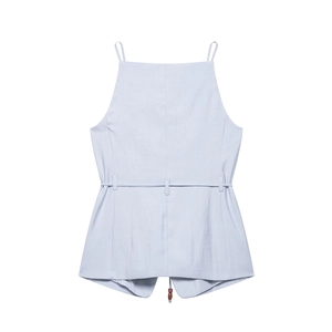 Light blue halter neck top with a waist belt detail and spaghetti straps on white background
