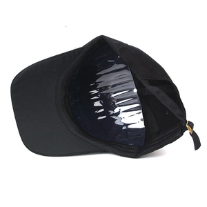 Detail of black cotton baseball cap interior with adjustable metal buckle and inner support