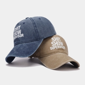Washed cotton baseball caps in denim blue and khaki with Shit Show Supervisor print