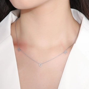 Close-up of silver MOM letter pendant necklace worn by a model for Mother's Day gift