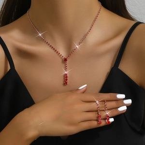 Elegant bridal jewelry set with red crystal necklace and matching drop earrings on a model