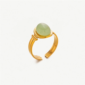 Detail shot of vintage gold-plated ring featuring an oval light green natural stone inlay