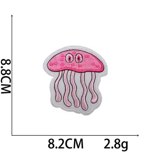 Macro shot of pink embroidered jellyfish patch with dimension markings of 8.8x8.2cm