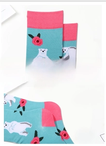 Detailed view of elastic cuffs on knitted socks with polar bear and rose patterns
