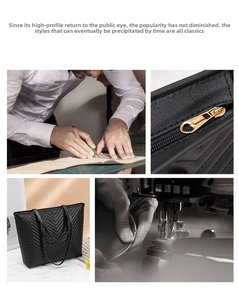 Detail of V-shaped stitching and golden zipper on black leather tote travel bag