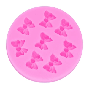 Pink silicone mold featuring 8 bow-shaped cavities for baking and cake decoration