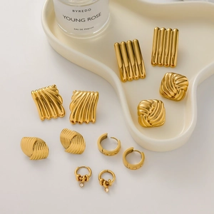 Macro shot of 18k gold plated stainless steel earring set with geometric textures