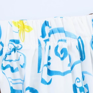Close-up of elastic waistband detail on white midi skirt with blue and yellow floral print