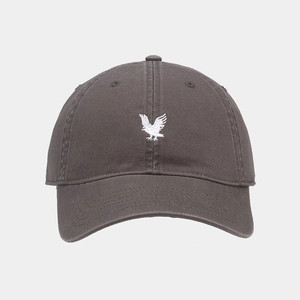 Close-up of detailed white eagle embroidery on a vintage charcoal grey baseball cap