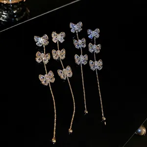 Boucles d'oreilles longues à pampilles avec nœud papillon en zircon argent et or