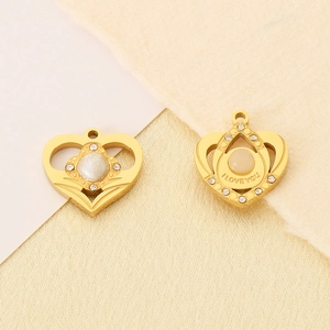 Detailed view of gold heart pendants with zircon stones and I LOVE YOU engraving