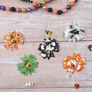 Handmade Halloween hair clips set with pumpkin, ghost and spider ribbon bows on wood