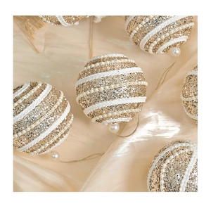 Macro detail of Christmas foam ball with gold sequins and white pearl beads decoration