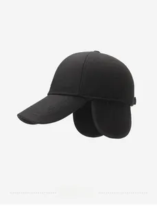Detailed side view of black winter baseball cap with ear flaps and logo embroidery