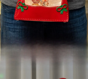 Macro detail of red Christmas lantern ornament with miniature reindeer and Santa scene