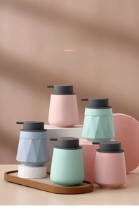 Close-up of ceramic soap dispensers with matte finishes and geometric textures