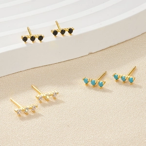 Three pairs of gold-plated bar stud earrings with black, turquoise, and clear zircons