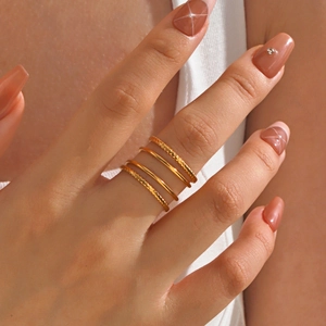 Set of four minimalist gold stainless steel rings with smooth and twisted textures