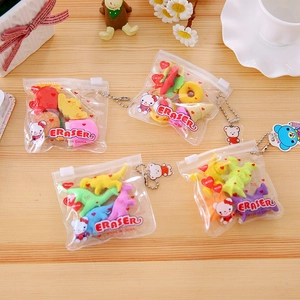 Set of creative cartoon erasers for kids featuring dinosaurs and desserts on wood background