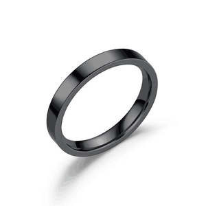Detailed close-up of polished black titanium steel band ring with smooth mirror finish