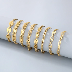 Detail of eight golden stainless steel bracelets in pig nose and geometric link styles