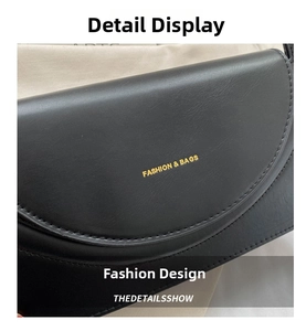 Detail der schwarzen Lederhandtasche mit goldenem Fashion & Bags Logo und feinen Nähten